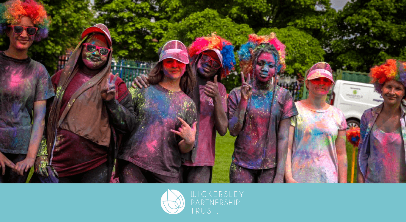 students covered in paint from colour run